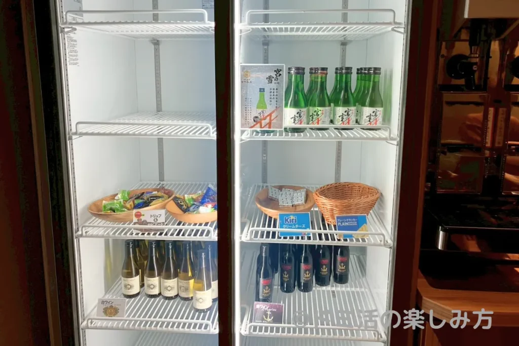 ドーミーイン四日市のDOMINISTA CLUBラウンジ内のワインやおつまみが入った冷蔵庫