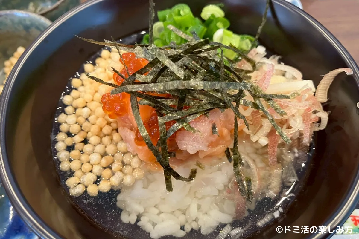 ドーミーイン千歳の朝食のいくらとサーモンの海鮮手まりをご飯に載せている写真